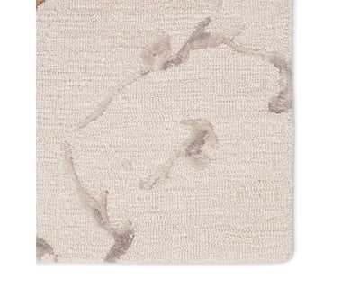 A rectangular area rug with a light gray color and a marble-like pattern, indicating a hand-tufted construction.