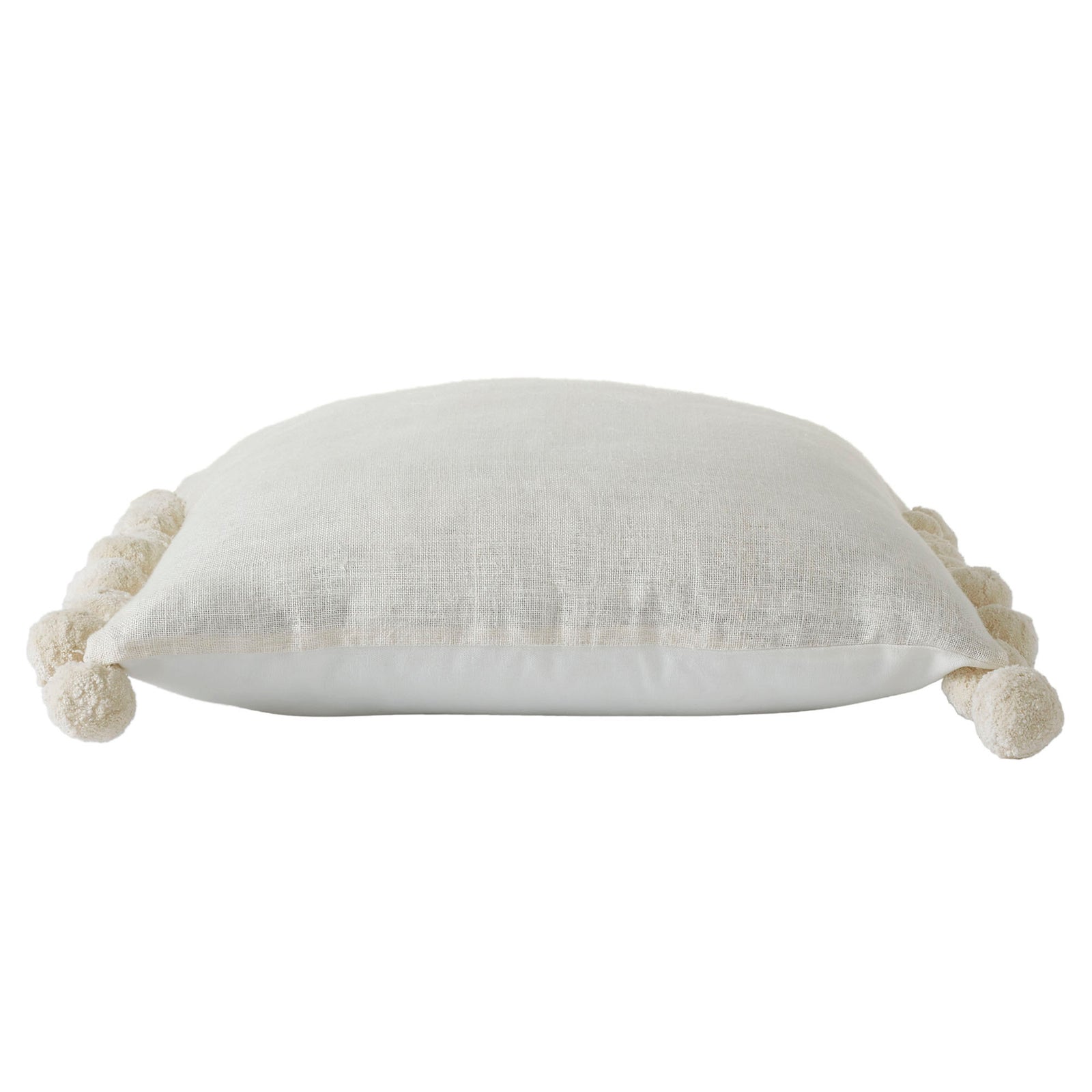 A square-shaped decorative pillow with solid pattern and pom pom detailing on the edges, primarily in a natural white color.