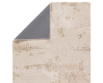 A beige and gray area rug with a textured design, hand tufted construction, and a viscose and wool blend.
