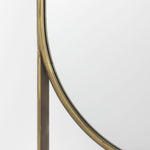 An oval-shaped full-length mirror with an antique-gold finish and a decorative bezel.