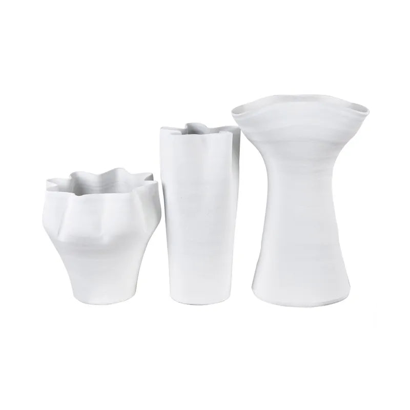 Set of three white ceramic vases on a white background