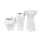 Set of three white ceramic vases on a white background