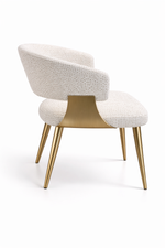 Chair with white upholstered backrest and gold legs on a white background