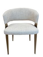 Chair with light blue patterned fabric and wooden legs on a white background