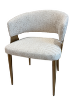 Chair with textured beige cushioned seat and backrest on a white background