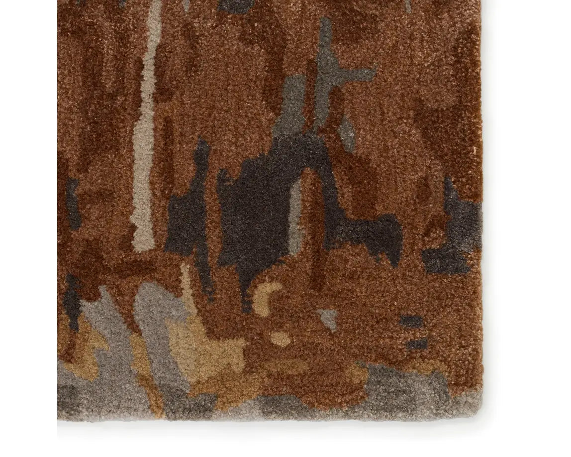 A rectangular area rug featuring a gray and brown color scheme with a textured design.