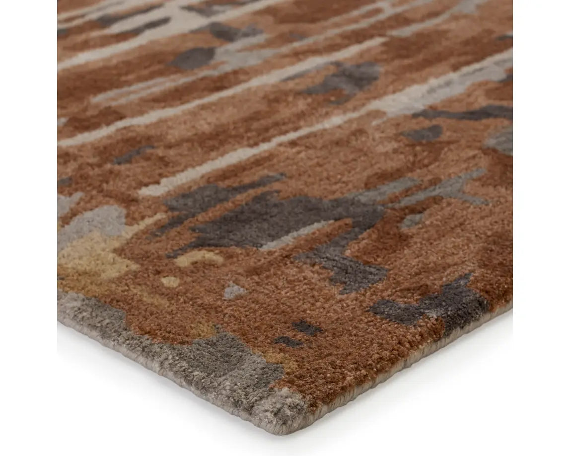 A rectangular area rug featuring a gray and brown color scheme with a textured design.