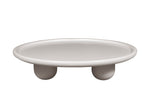 A white, round coffee table with a smooth top and three pedestal legs.