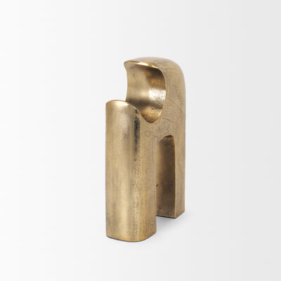 Gold metal sculpture of interlocking shapes on a white background