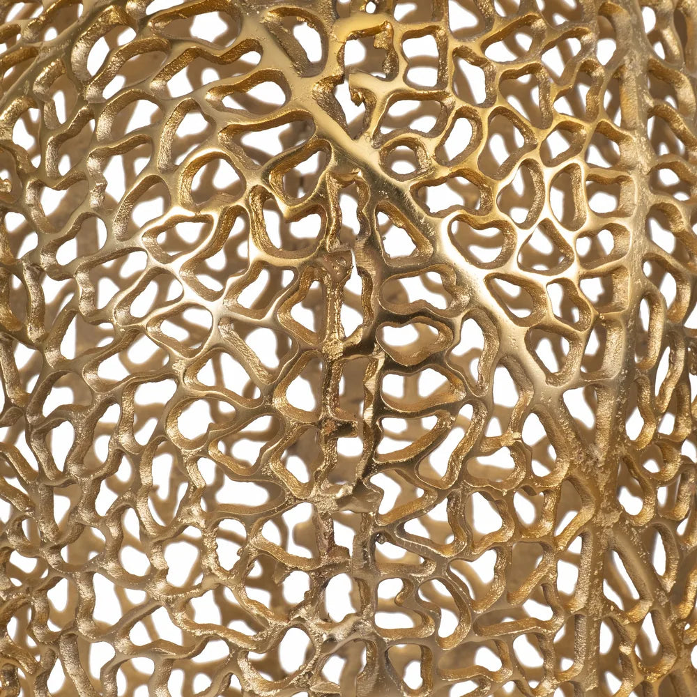 Close-up of a gold, intricately patterned metal object