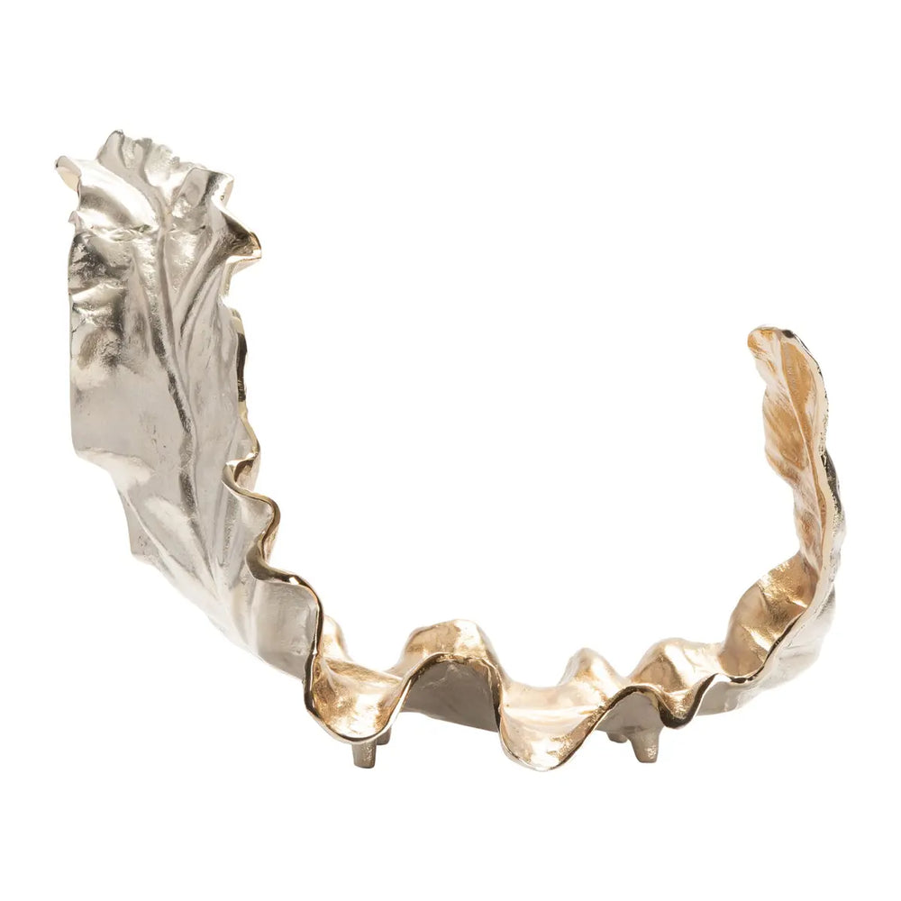 A decorative gold leaf object with a wavy and textured design, predominantly gold in color with some silver accents.