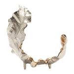 A decorative object with a gold leaf design