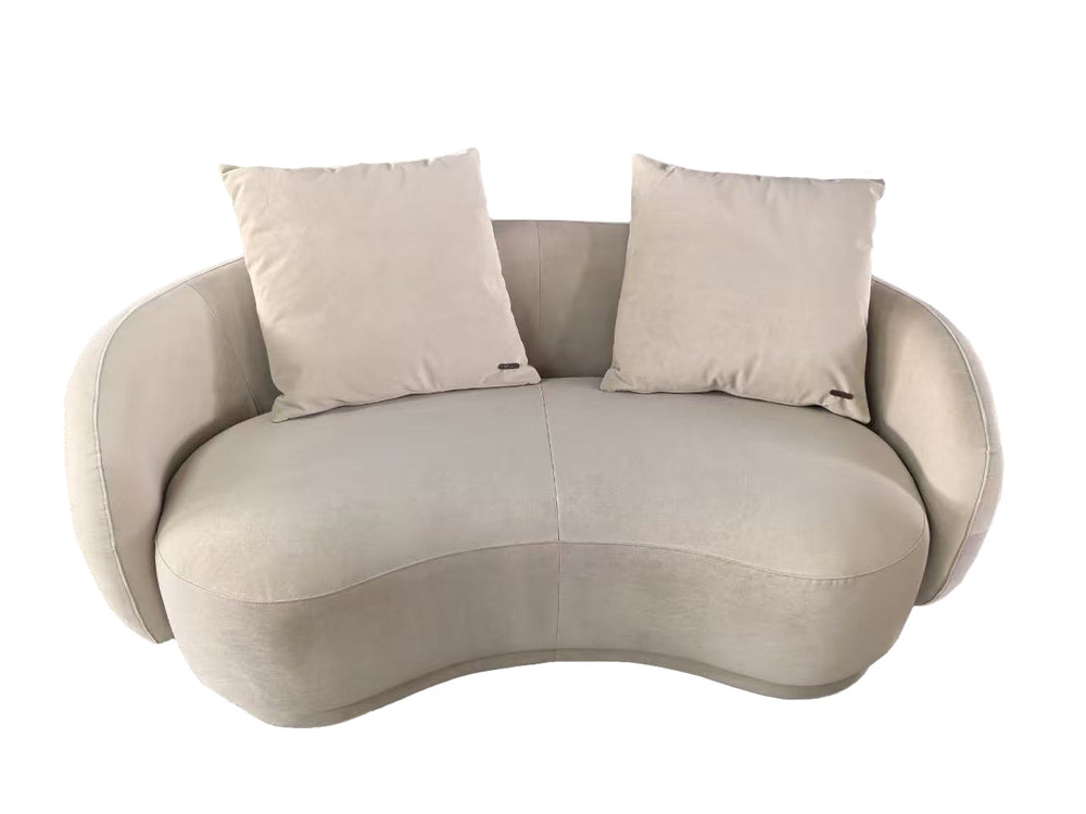Beige wavy sofa with two cushions on a white background