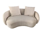 Beige wavy sofa with two cushions on a white background