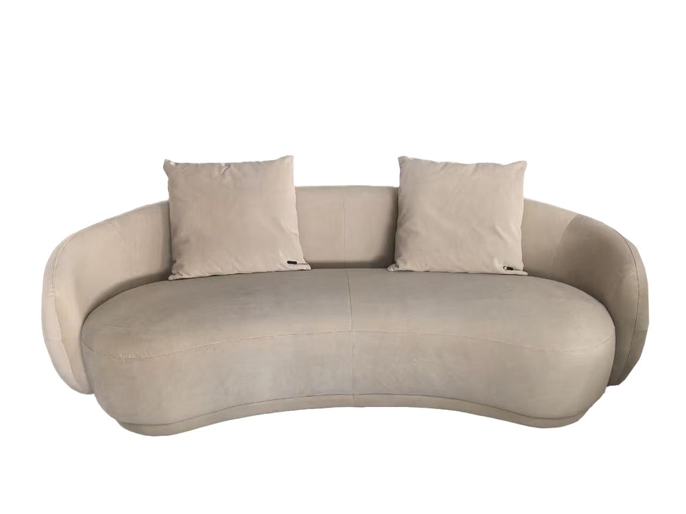 Beige sofa with two cushions on a white background