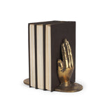 A gold-colored cast iron hand-shaped bookend.