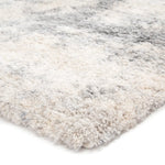 Close-up of a textured rug with a neutral color palette on a white background