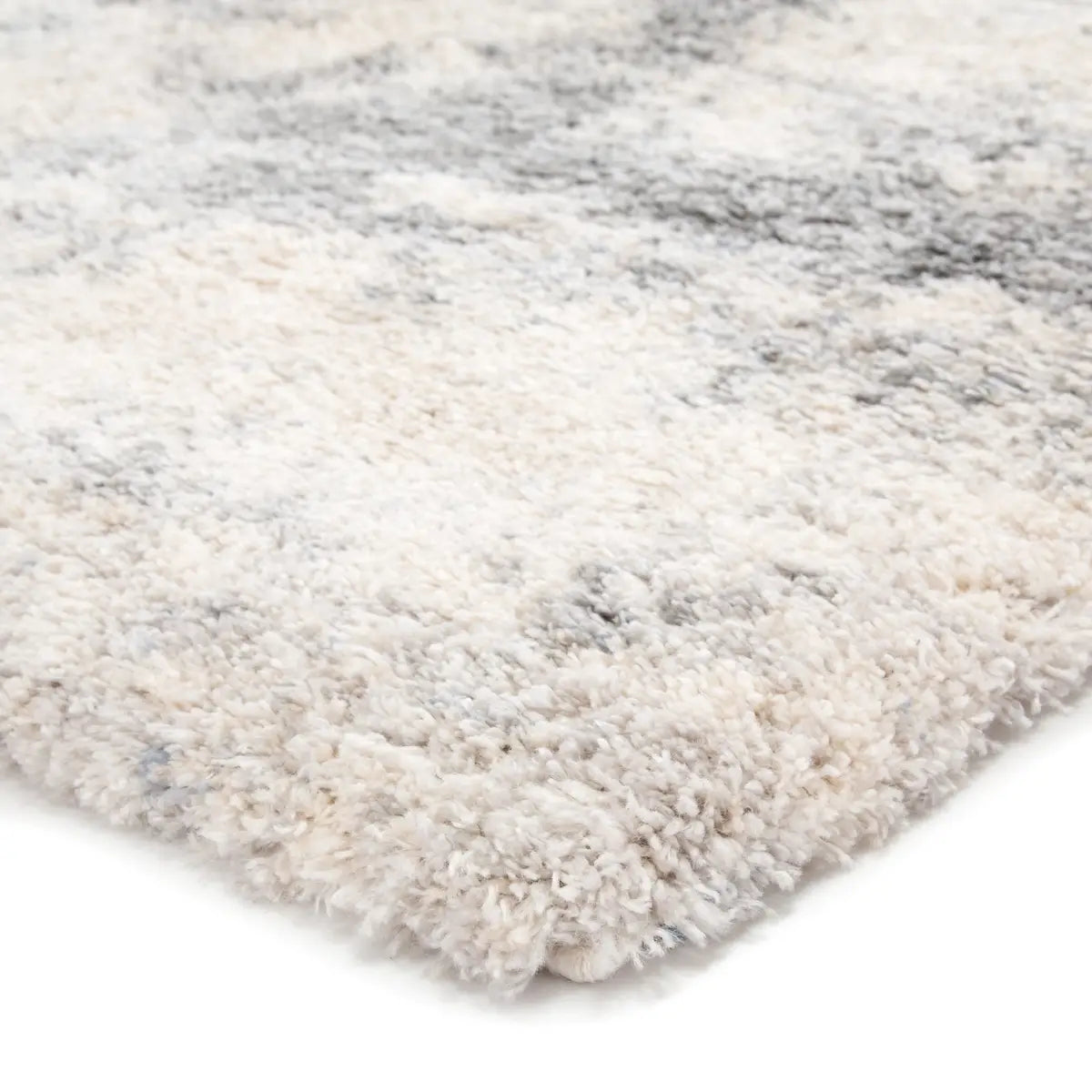 Close-up of a textured rug with a neutral color palette on a white background