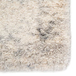 Close-up of a textured beige and gray rug