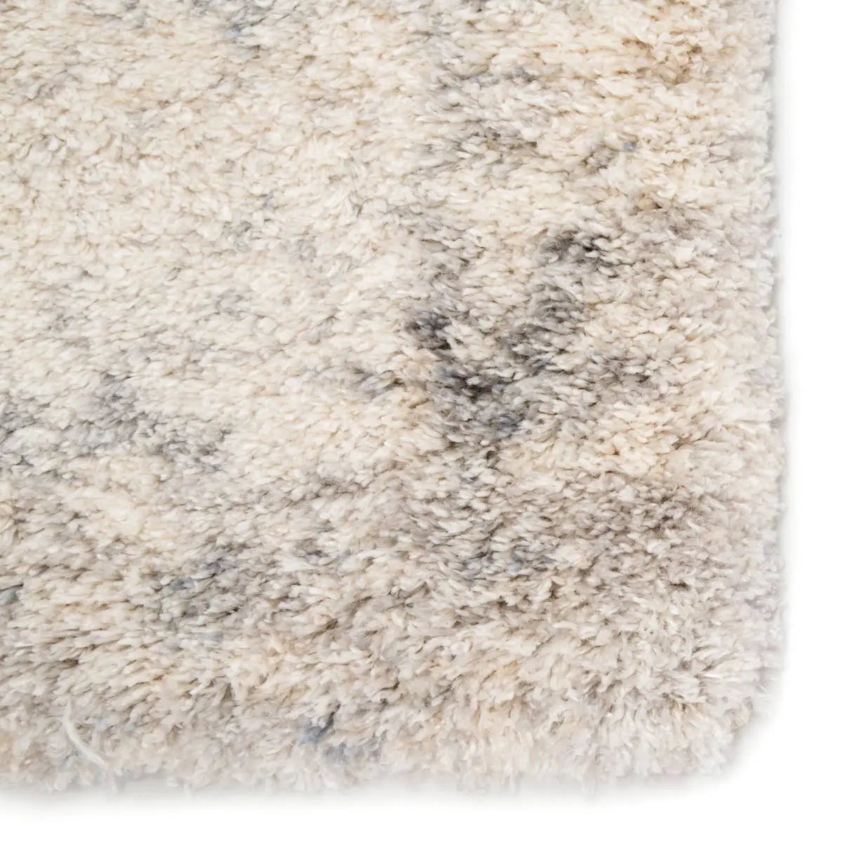 Close-up of a textured beige and gray rug