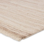A beige area rug with a solid pattern and flat texture.
