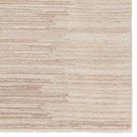 A beige area rug with a solid pattern and flat texture.