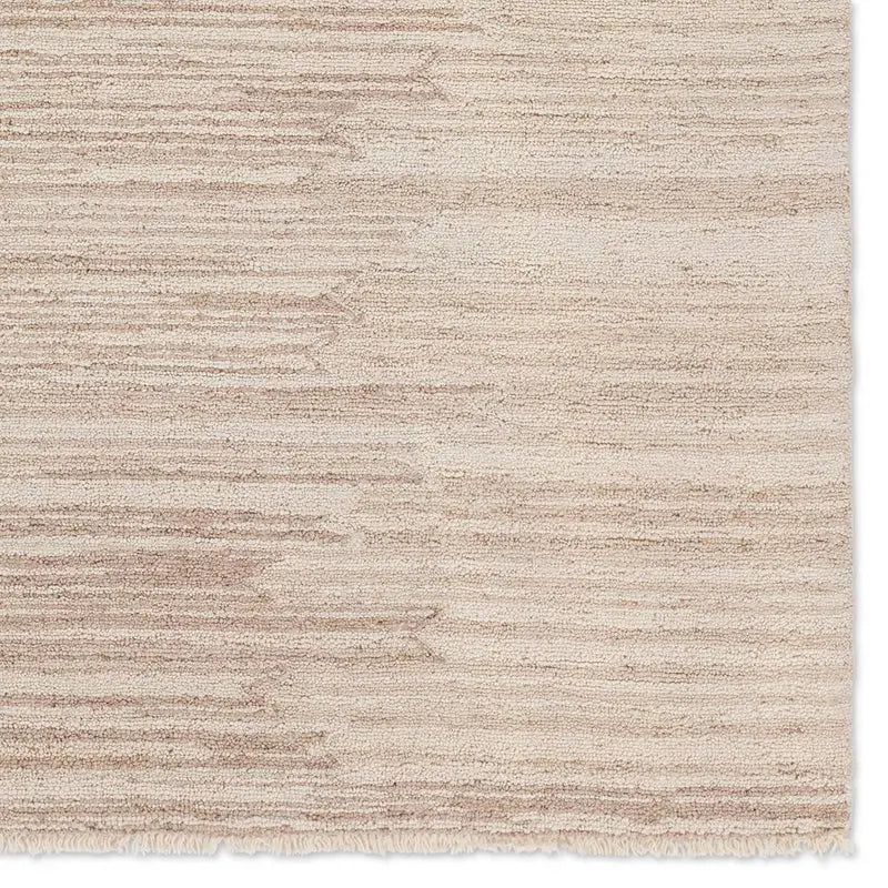 A beige area rug with a solid pattern and flat texture.