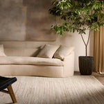 A beige area rug with a solid pattern and flat texture.