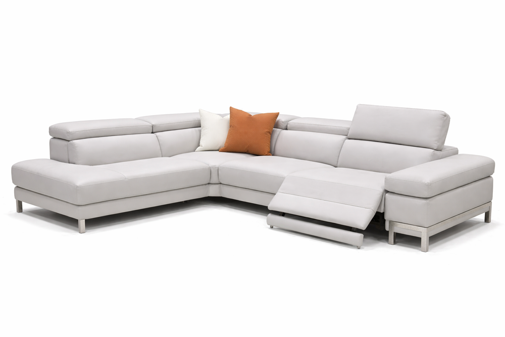 Gray sectional sofa with a brown pillow on a white background