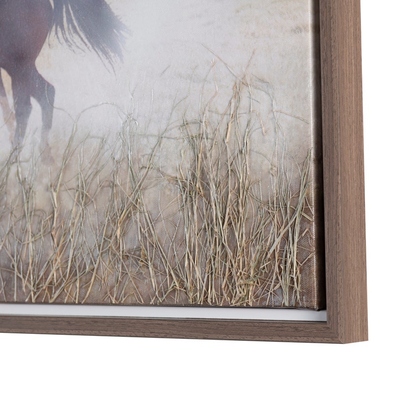 A hand-painted canvas wall art depicting a scene with horses running in an open field with mountains in the background.