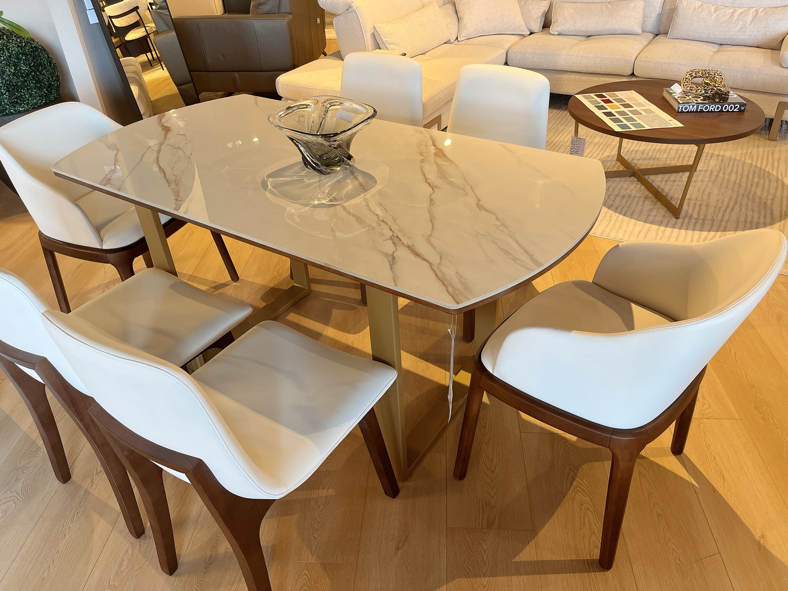 Dining table with chairs in a room with a couch and coffee table.