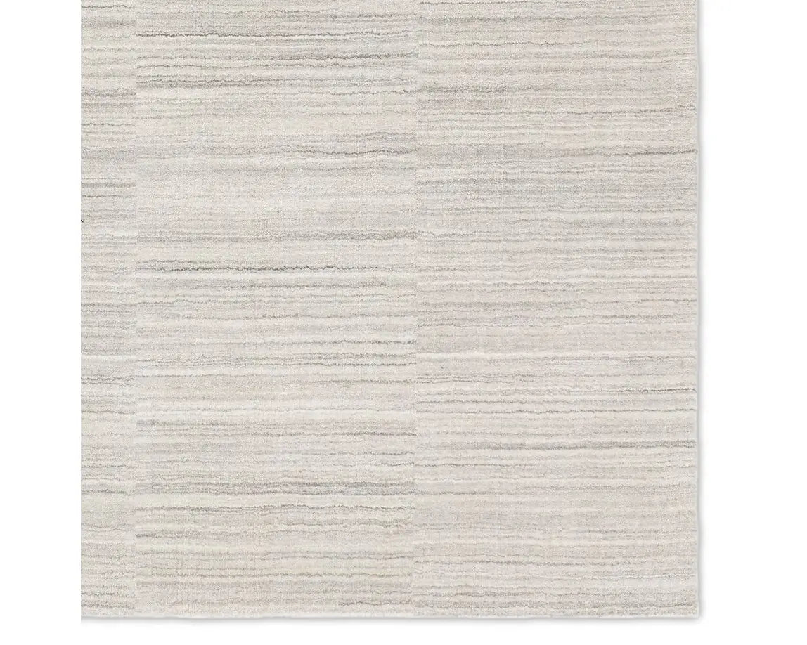 A rectangular, solid white area rug with a textured design