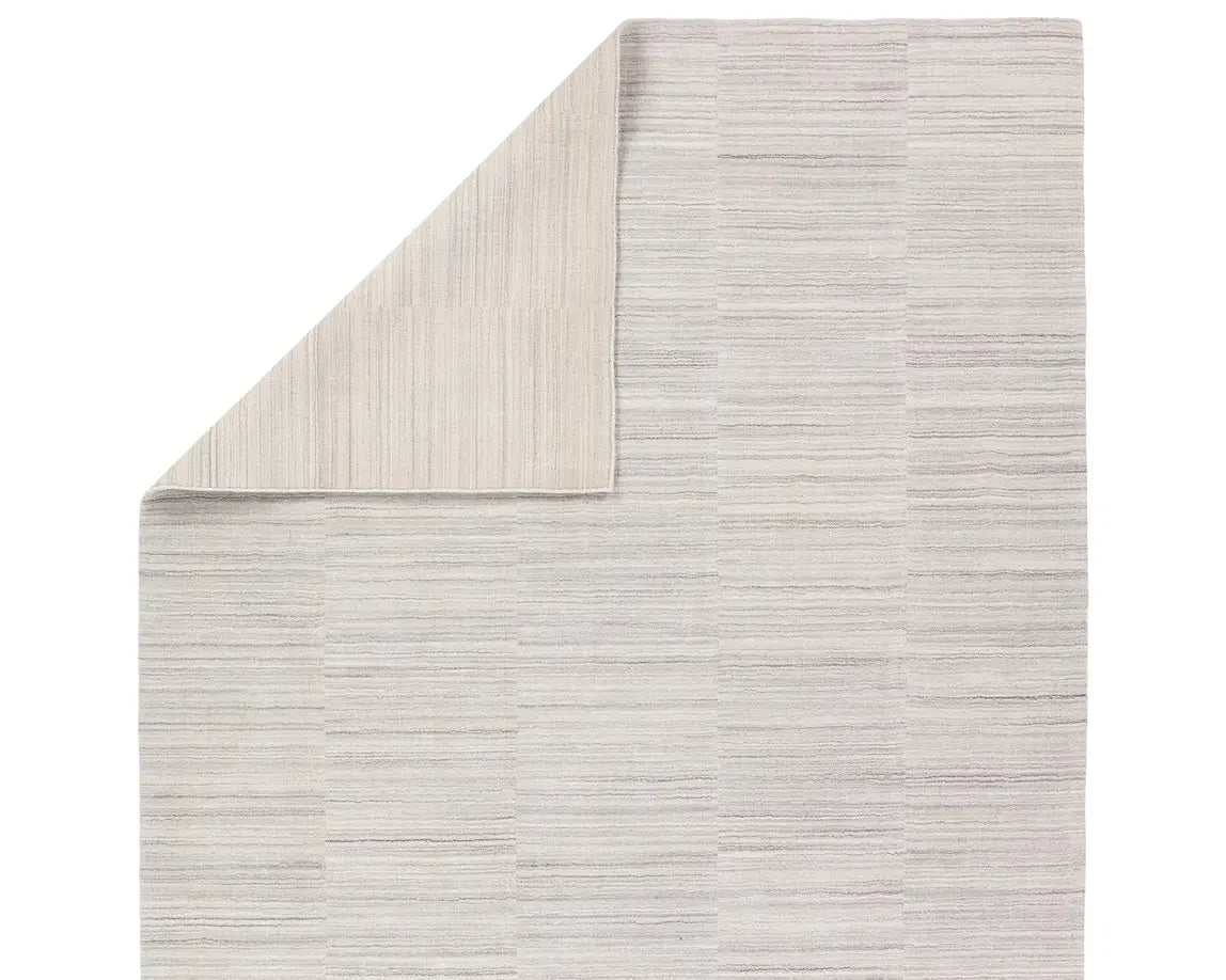 A rectangular, solid white area rug with a textured design