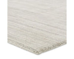 A rectangular, solid white area rug with a textured design