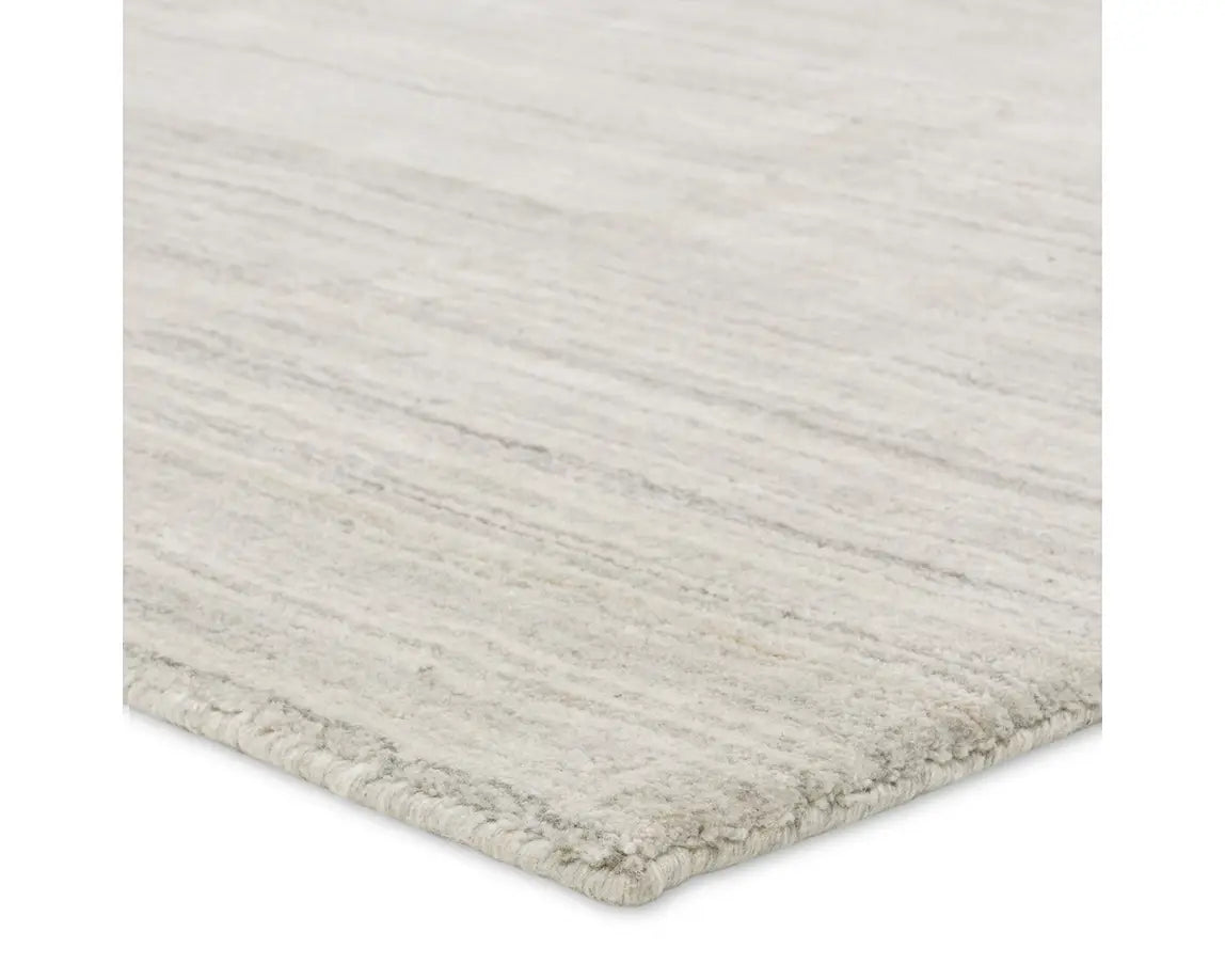 A rectangular, solid white area rug with a textured design