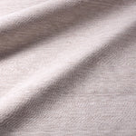Close-up of textured beige fabric with light and shadow