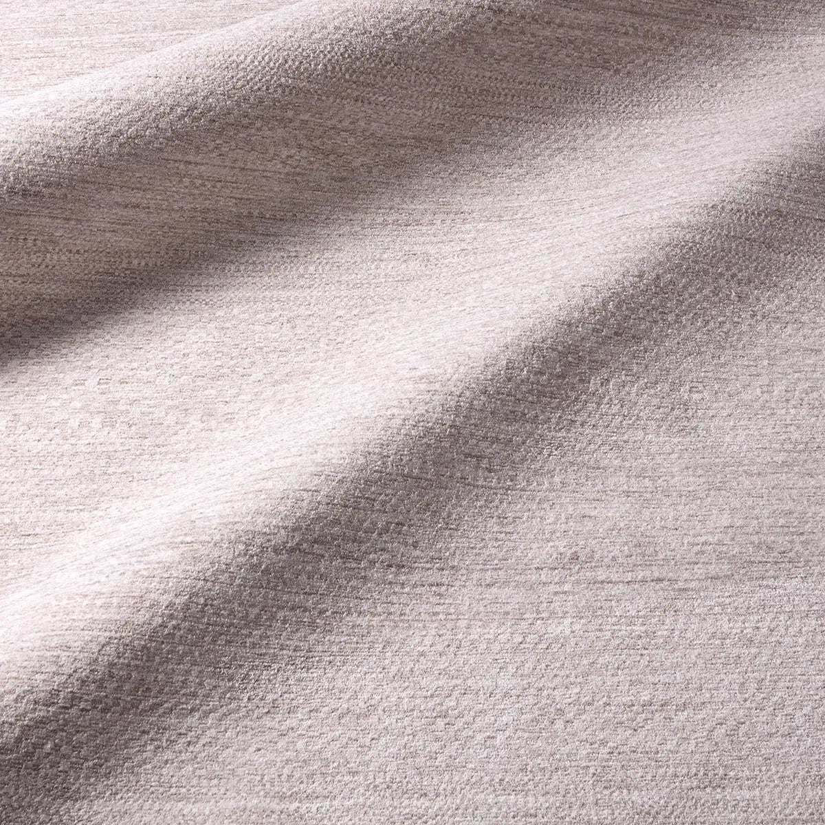 Close-up of textured beige fabric with light and shadow
