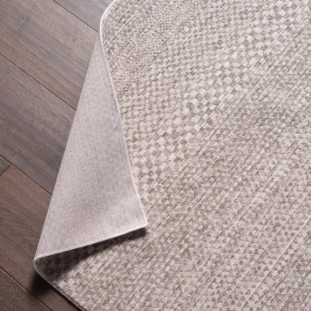 Gray textured rug on a wooden floor