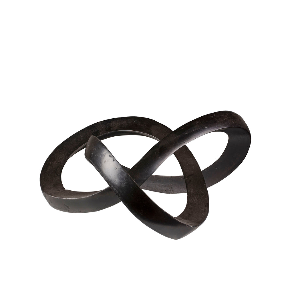 Black metal sculpture of intertwined rings on a white background