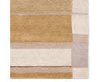 A rectangular area rug featuring a geometric pattern with beige, gray, and yellow colors.