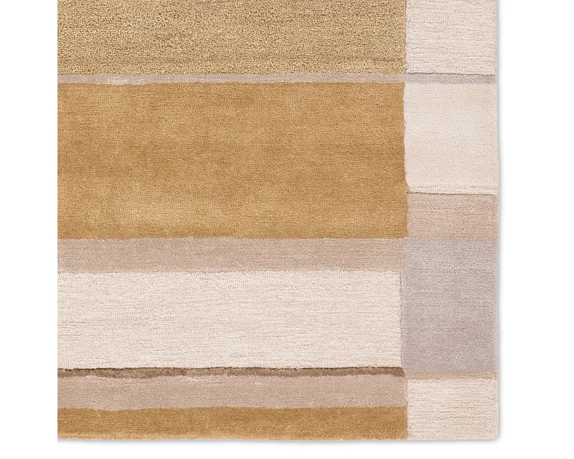 A rectangular area rug featuring a geometric pattern with beige, gray, and yellow colors.