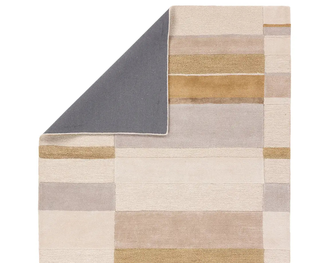 A rectangular area rug featuring a geometric pattern with beige, gray, and yellow colors.