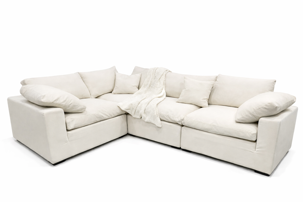 White sectional sofa with cushions on a white background