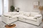 White sectional sofa in a living room with decor elements.