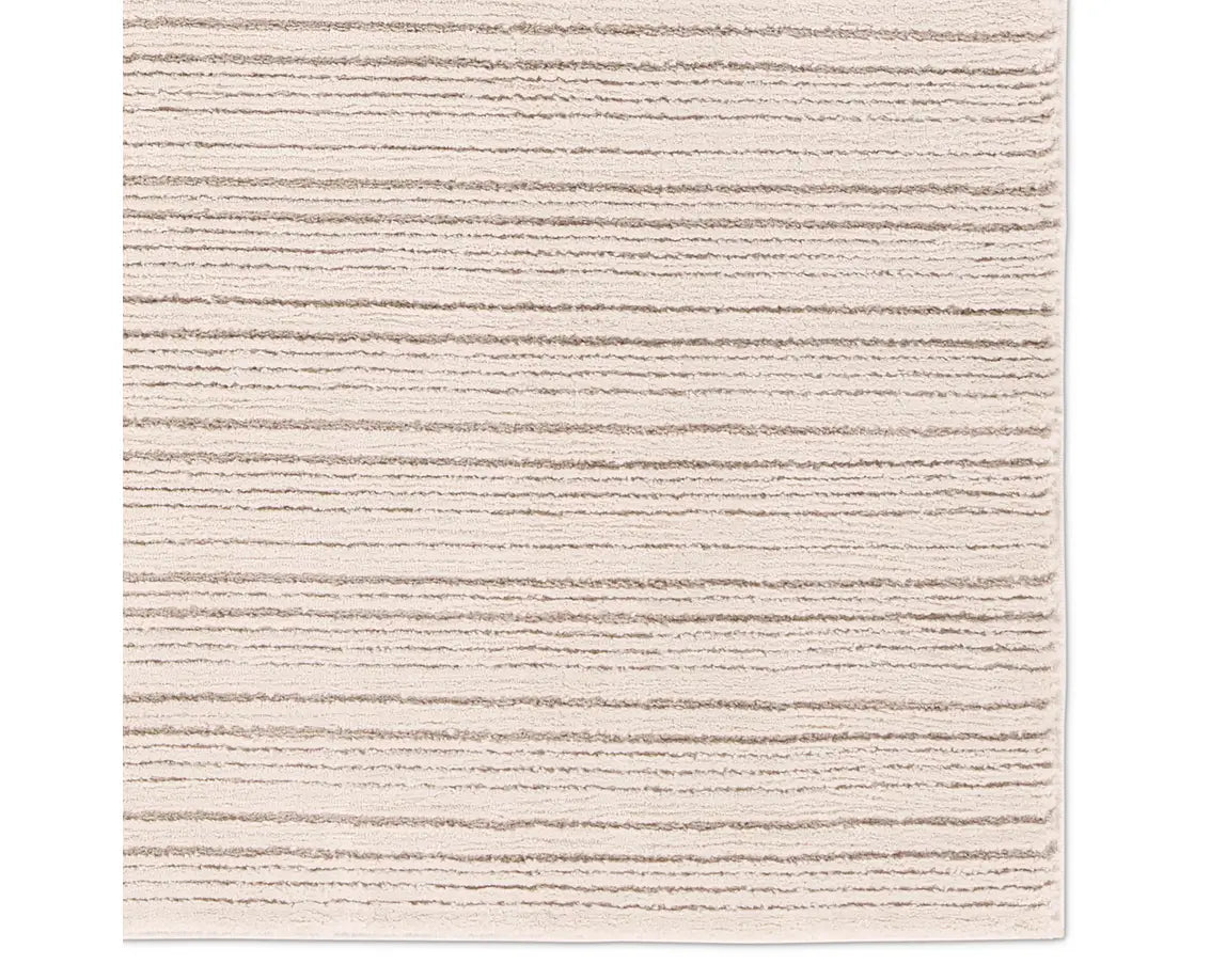A beige and white striped area rug, power loomed with a flatweave construction.