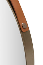 A round accent mirror with a metallic frame and a simple, elegant design.