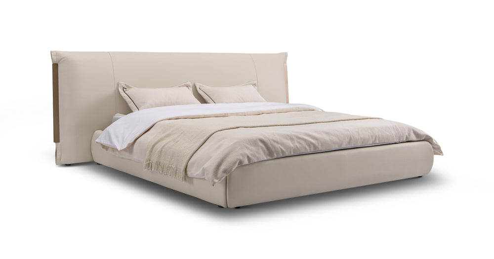 Beige upholstered bed with white bedding on a white background