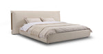 Beige upholstered bed with white bedding on a white background