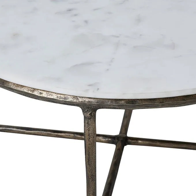 Round marble coffee table with a cast aluminum base featuring a natural white color and antique brass finish.