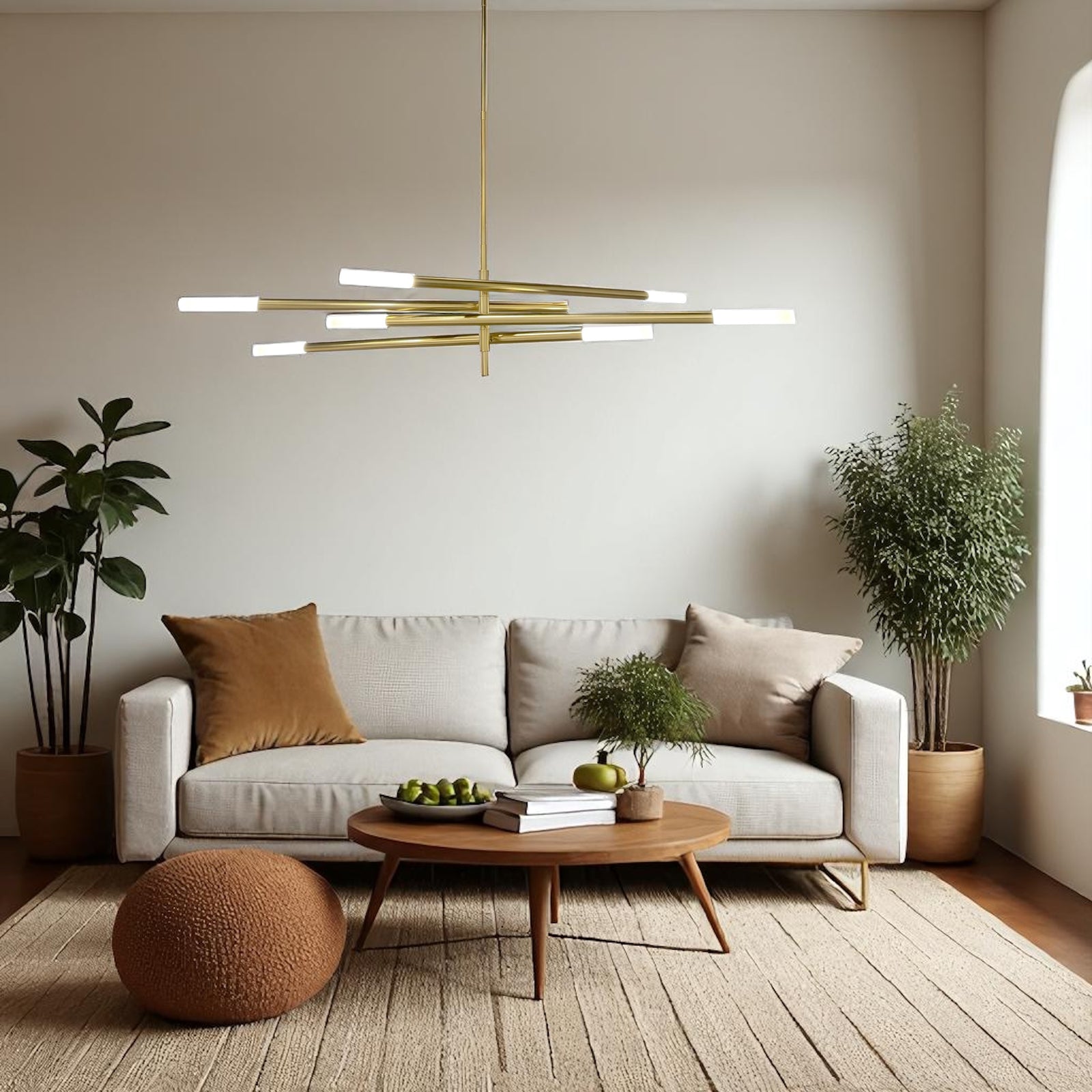 Modern living room with a white sofa, gold chandelier, and decorative items.
